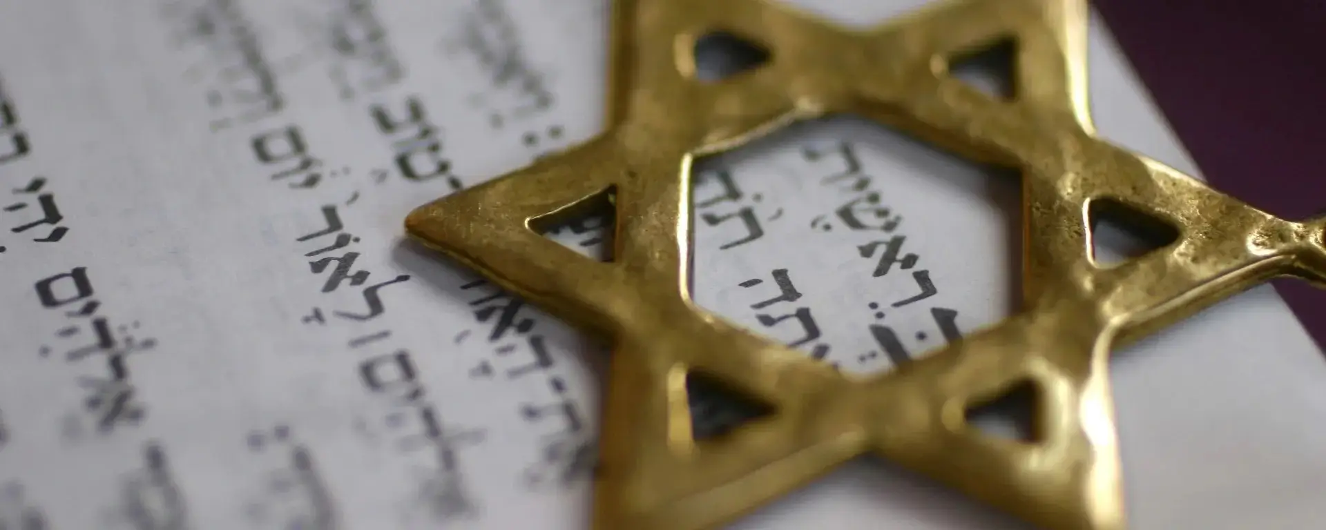 hebrew writing with a golden star of david